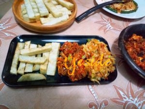 A plate of Dundun (fried wateryam) with Mackerel pepper sauce and sauteed cabbage and green beans