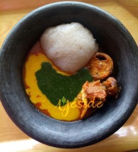 Lafun (Cassava) with Ewedu (Jute leaves), Gbegiri (beans soup) and pepper stew with Goat meat and Mackerel in a local Clay dish